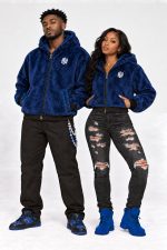 Couple wearing the Legacy Zip royal blue faux fur hoodies, men's and women's cropped